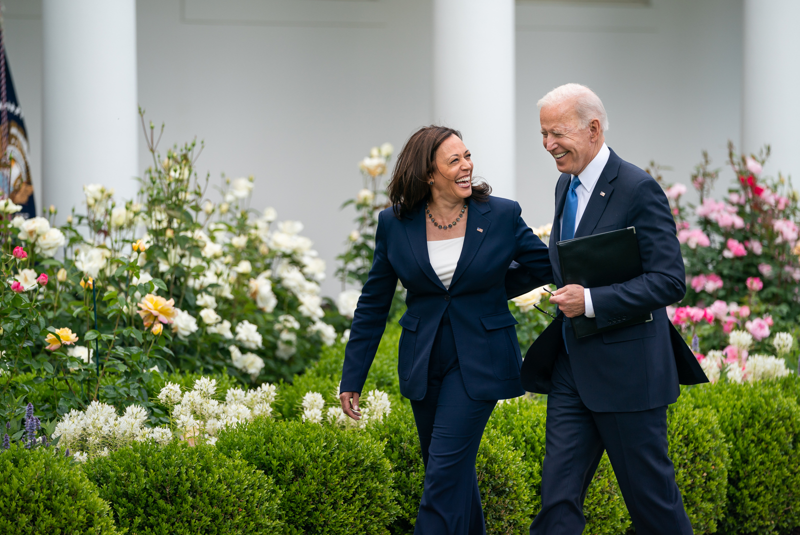 Joe Biden and Kamala Harris walking together in the Rose Garden of the White House